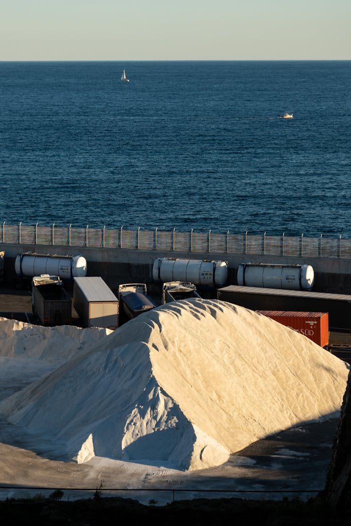 Seaside industrial area with salt piles and containers in Savona, Italy.